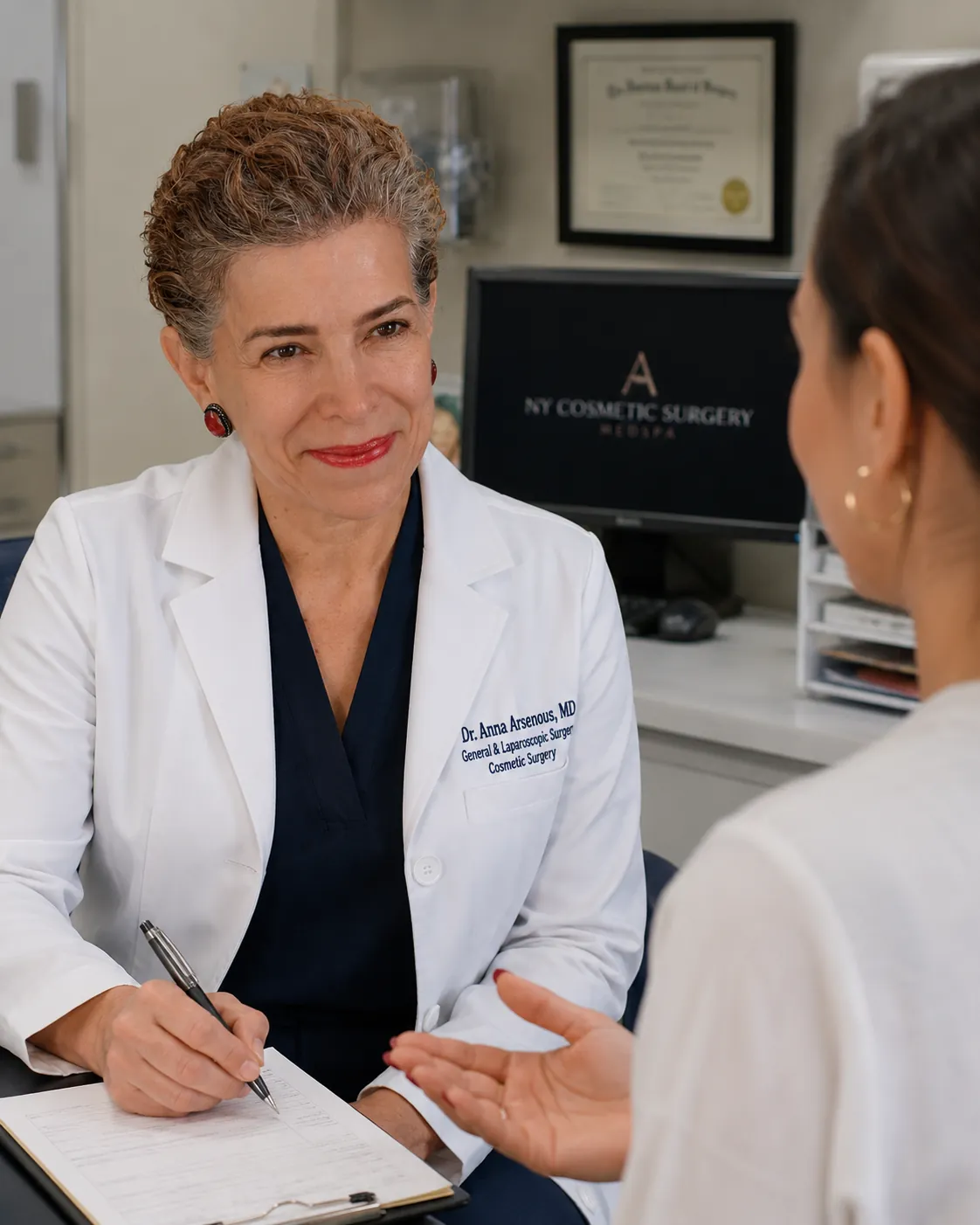 Dr. Anna Arsenous discussing breast reduction with a patient in Glendale, Queens